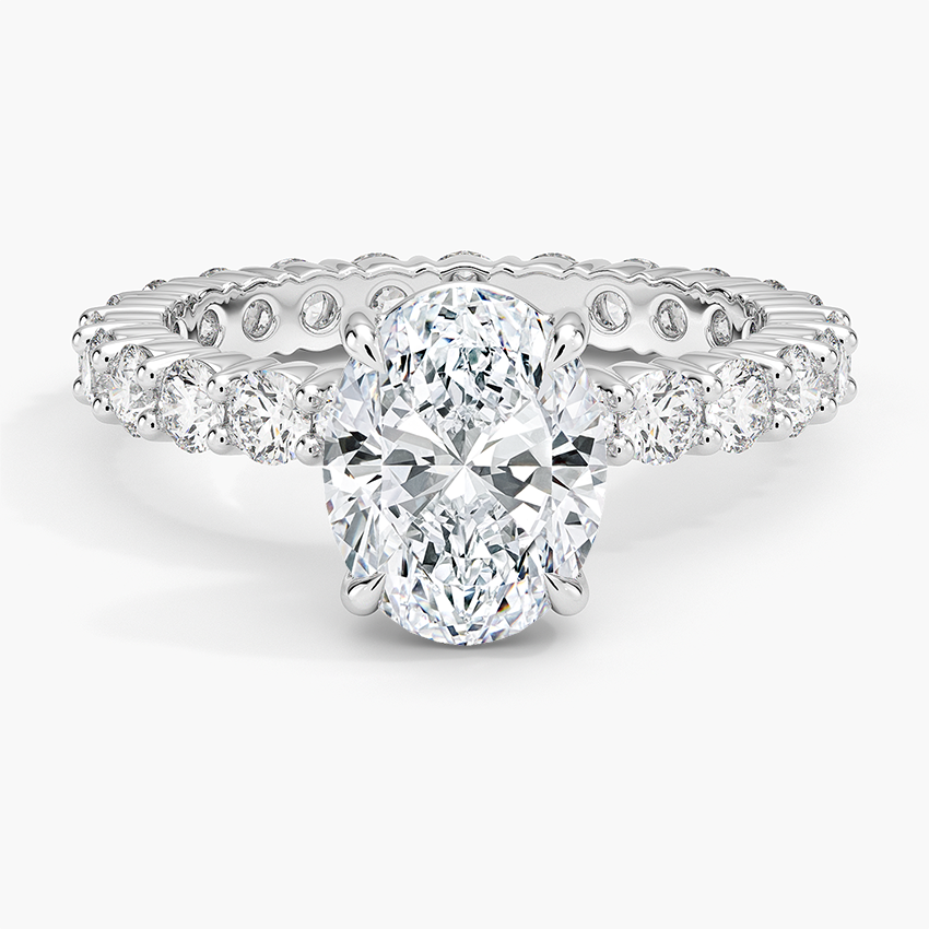 Oval moissanite engagement ring on a full eternity shared prong band in white gold, top view