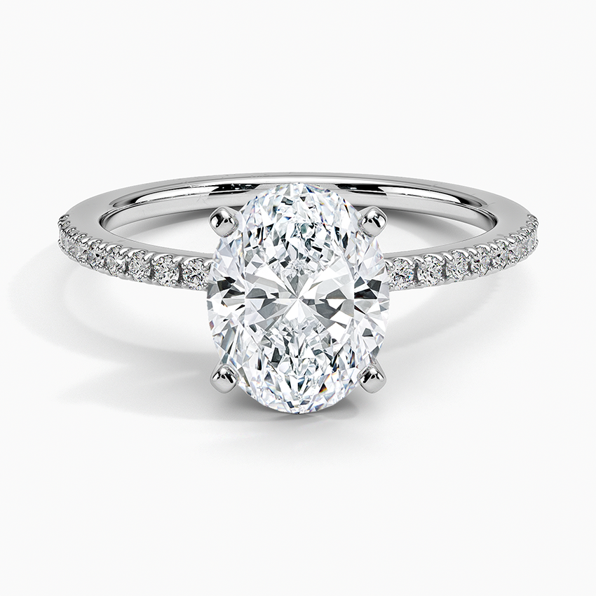 Oval moissanite with fine micropave shoulders on a slim white gold band, top view