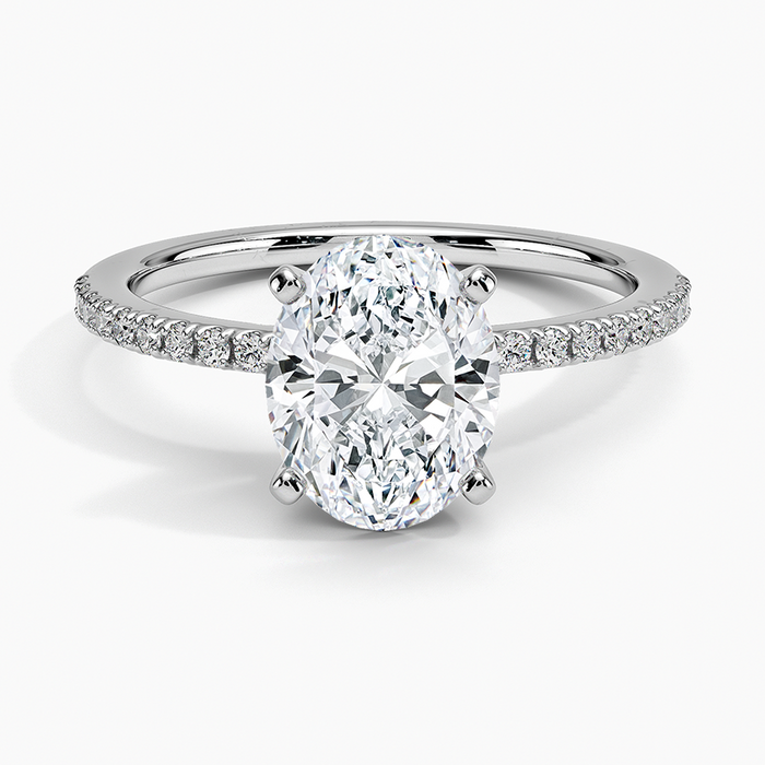 Oval moissanite with fine micropave shoulders on a slim white gold band, top view