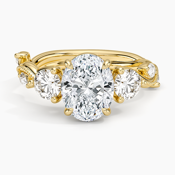 Oval moissanite five stone ring with graduated round accents in yellow gold, top view