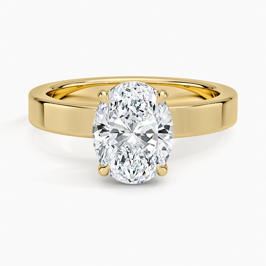 Oval moissanite solitaire on a 3mm flat edged yellow gold band, top view