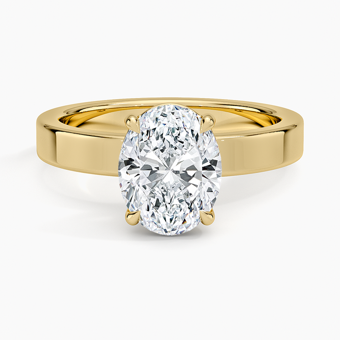 Oval moissanite solitaire on a 3mm flat edged yellow gold band, top view