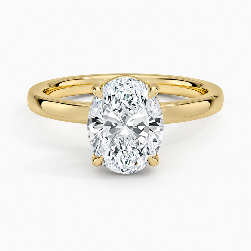 Oval moissanite low set on a flat top band in yellow gold, top view