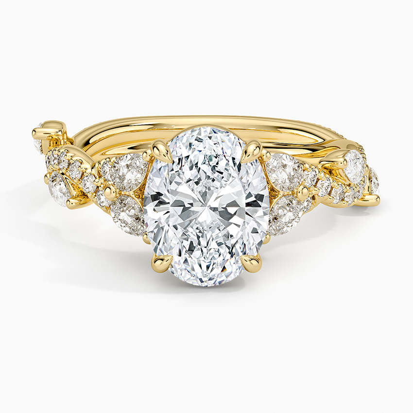 Oval moissanite with round petal clusters on a twisted yellow gold vine band, top view