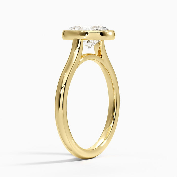 Side profile showing the bezel rim and split shank in yellow gold