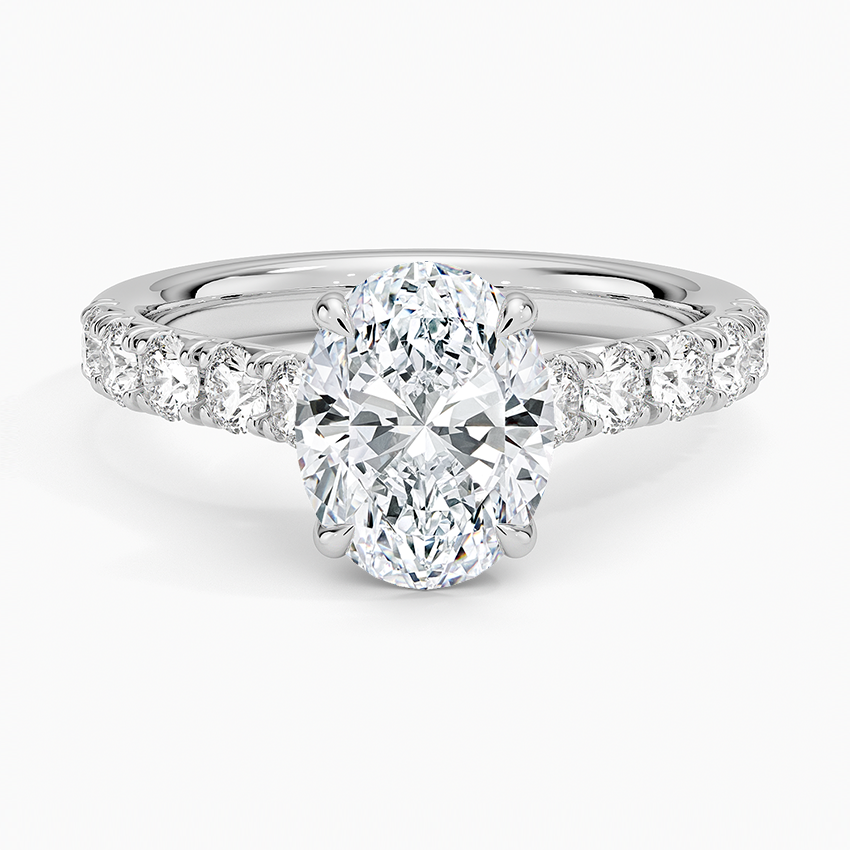 Oval moissanite with graduated pave on a flat topped white gold band, top view
