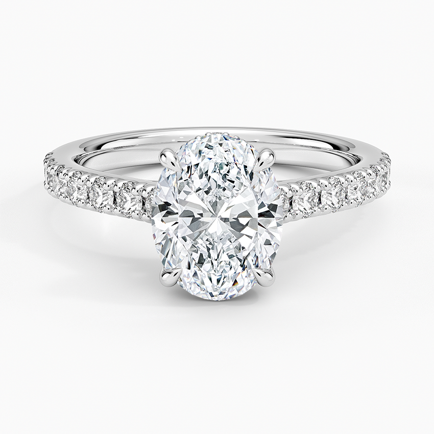 Oval moissanite ring with graduated pave shoulders in white gold, top view