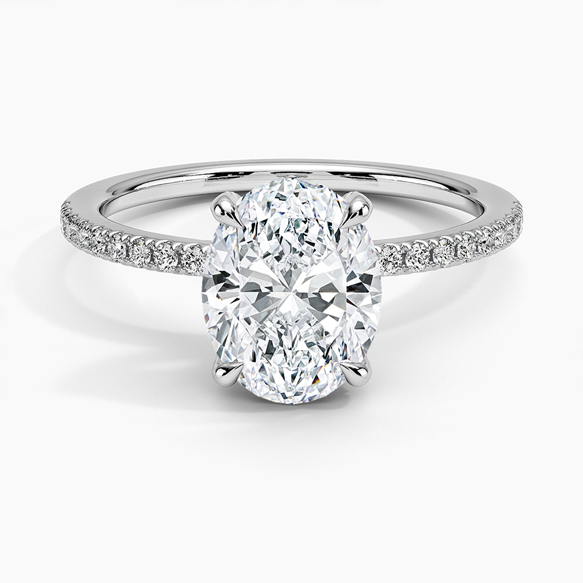 Oval moissanite on a half coverage micropave white gold band, top view
