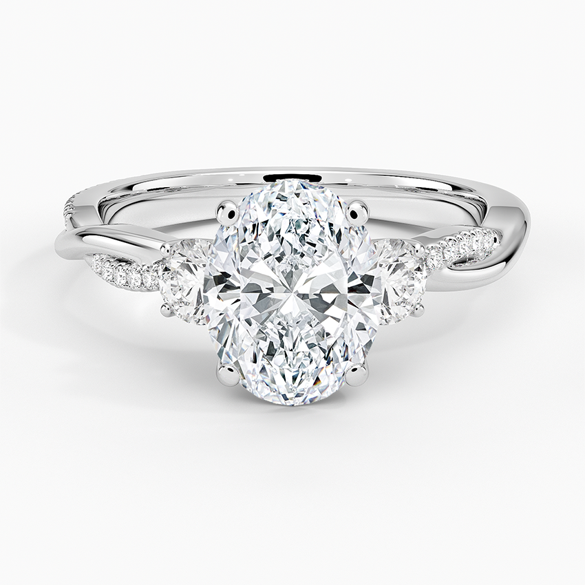 Oval moissanite with half moon side stones on a twisted pave white gold band