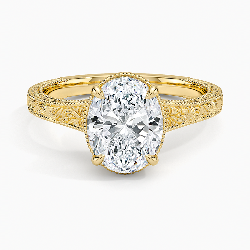 Oval moissanite on a hand engraved scroll and milgrain band in yellow gold, top view