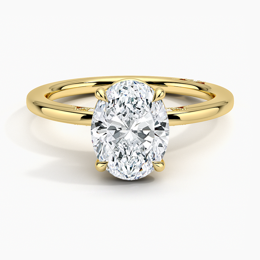 Oval moissanite on a plain thin band in yellow gold, top view