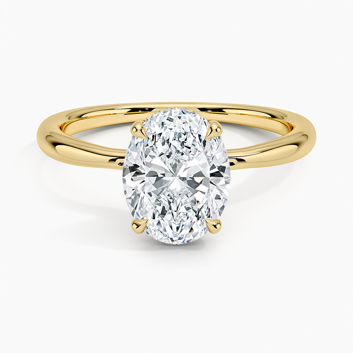 Oval moissanite hidden halo solitaire engagement ring in yellow gold, top view