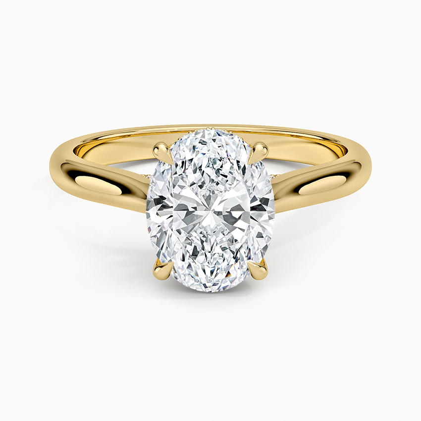 Oval moissanite on a plain cathedral yellow gold band, top view