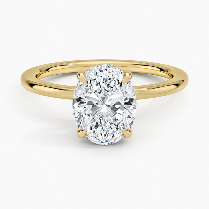 Oval moissanite solitaire on a plain slim yellow gold band, top view
