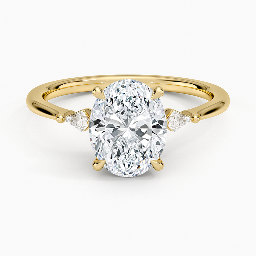 Oval moissanite with kite cut side stones in yellow gold, top view