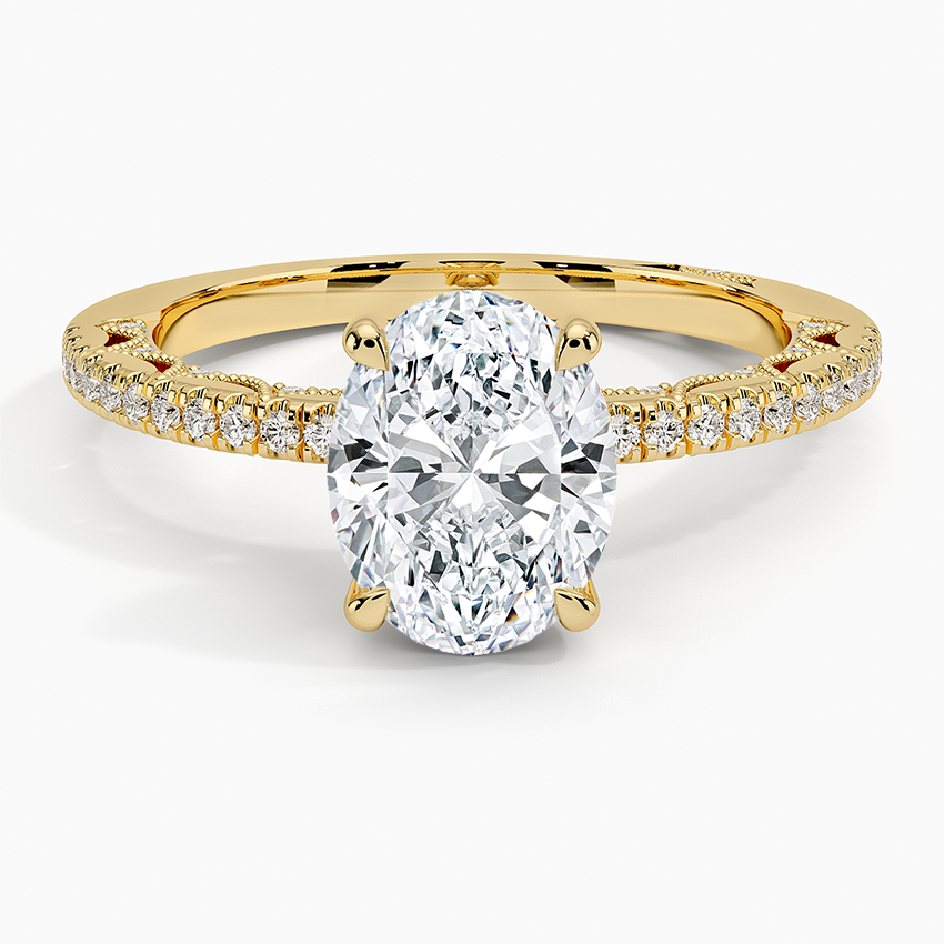 Oval moissanite on a slim knife edge pave band in yellow gold, top view