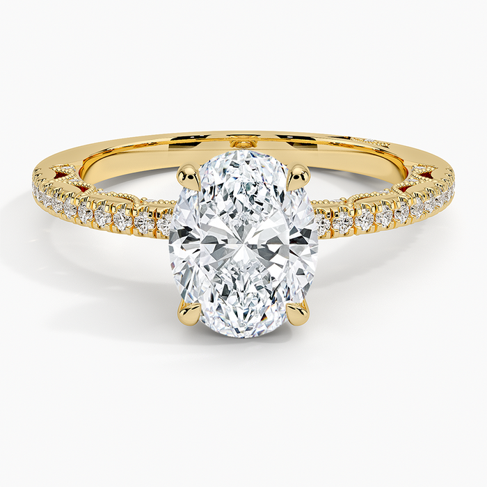Oval moissanite on a slim knife edge pave band in yellow gold, top view