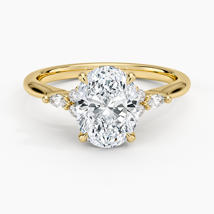 Oval moissanite leaf cluster accent engagement ring in yellow gold, top view