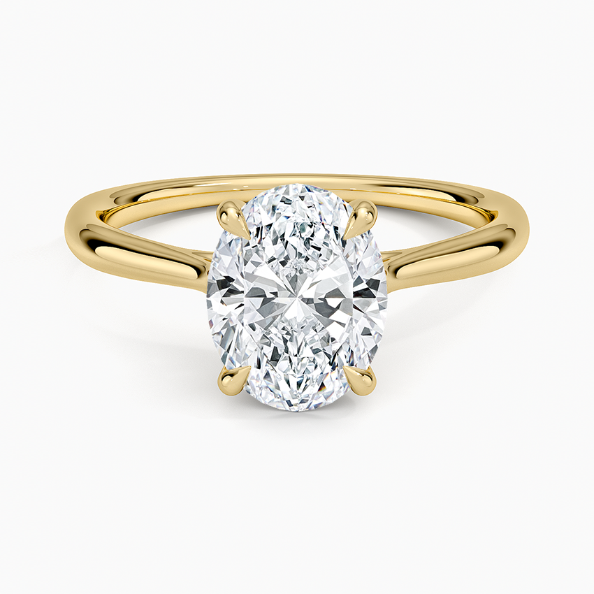 Oval moissanite solitaire with a looped ribbon gallery in yellow gold, top view