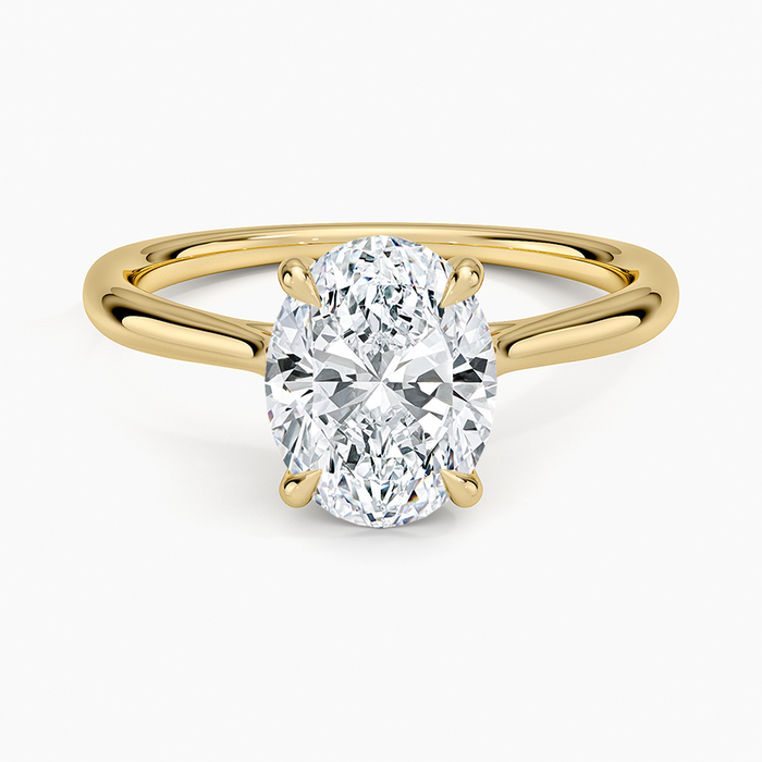 Oval moissanite solitaire with a looped ribbon gallery in yellow gold, top view