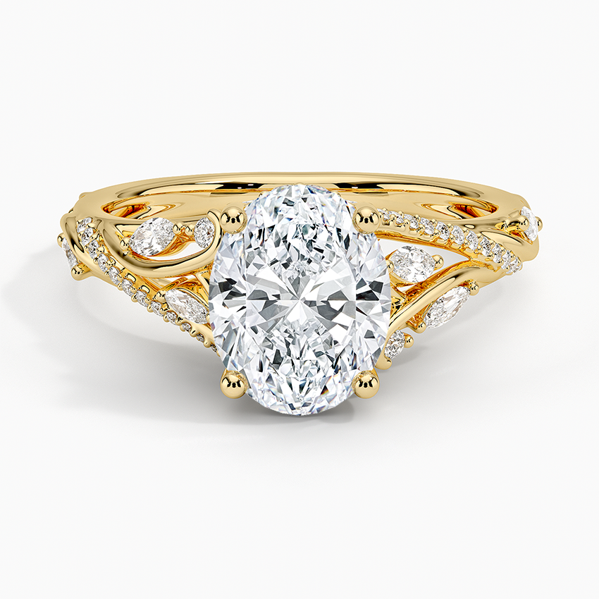 Oval moissanite ring with marquise and pear leaf accents on a scrolling vine in yellow gold, top view