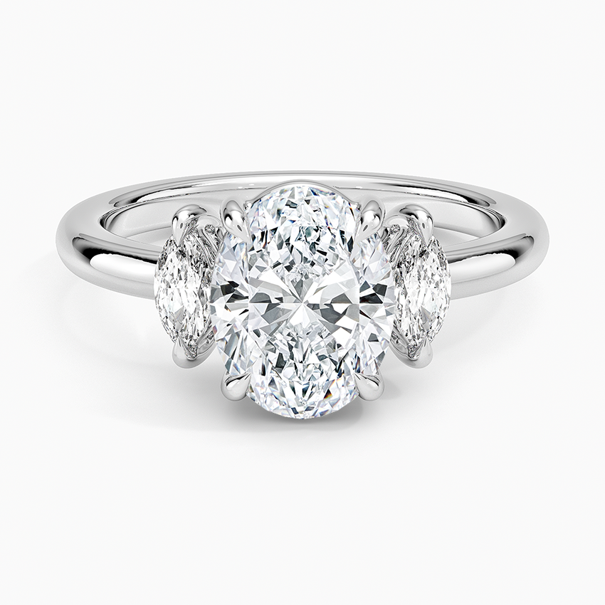 Oval moissanite three stone ring with upright marquise side stones in white gold, top view