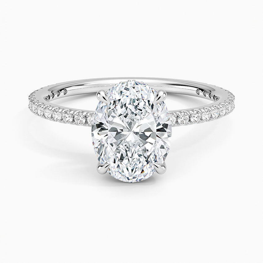 Oval moissanite ring with fine micropave eternity band in white gold, top view