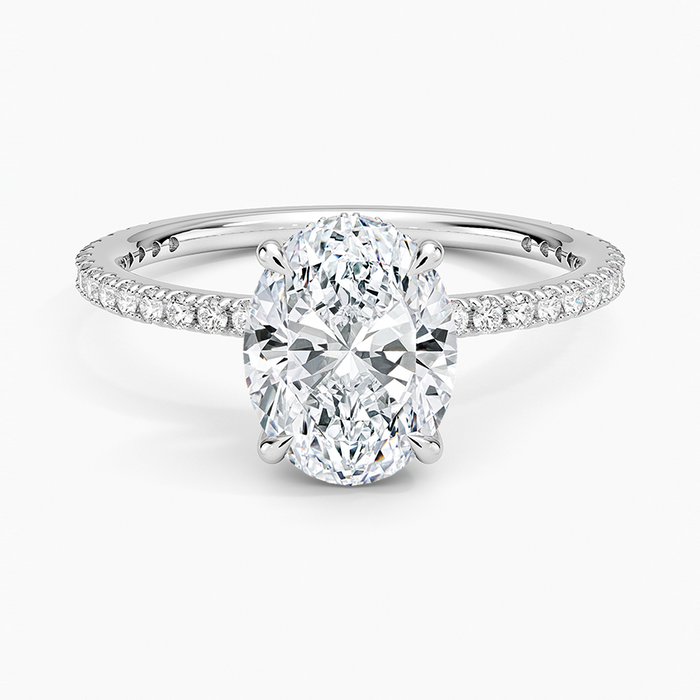 Oval moissanite ring with fine micropave eternity band in white gold, top view