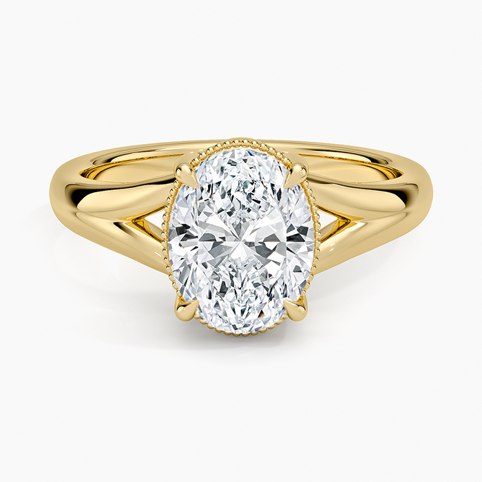 Oval moissanite in a milgrain collar on a split shank in yellow gold, top view