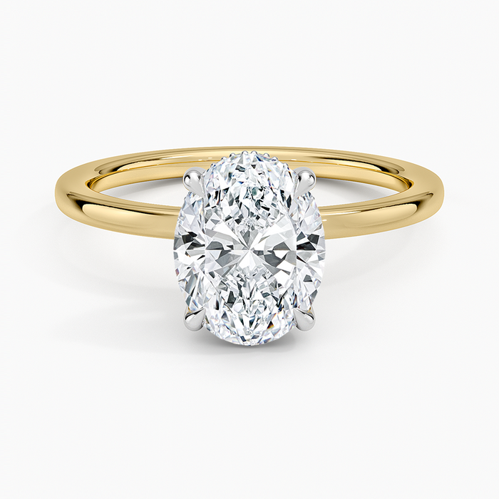 Oval moissanite mixed metal ring with white gold head and yellow gold band, top view