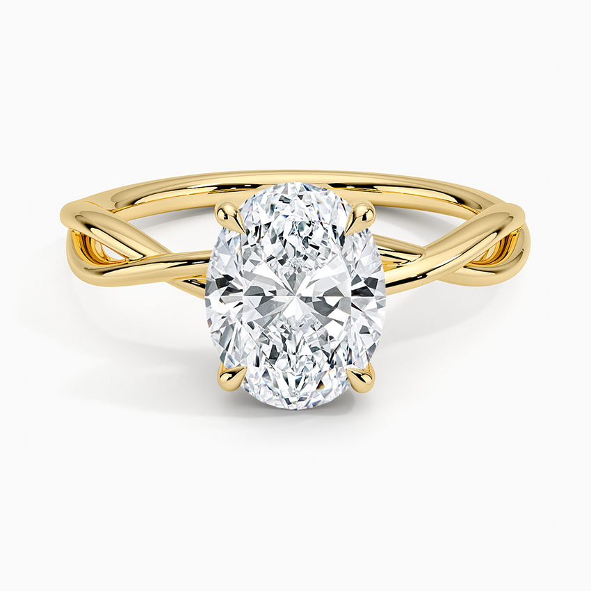 Oval moissanite solitaire on an open loop crossover band in yellow gold, top view