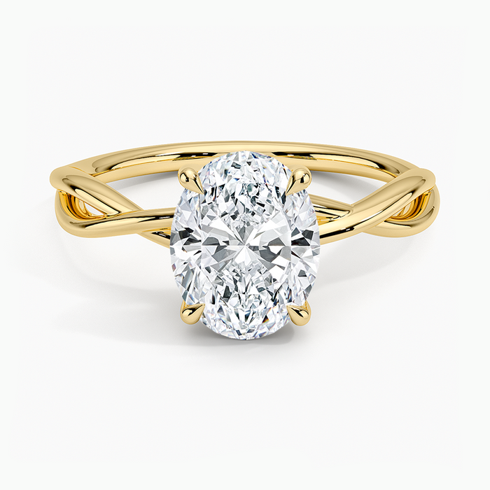 Oval moissanite solitaire on an open loop crossover band in yellow gold, top view
