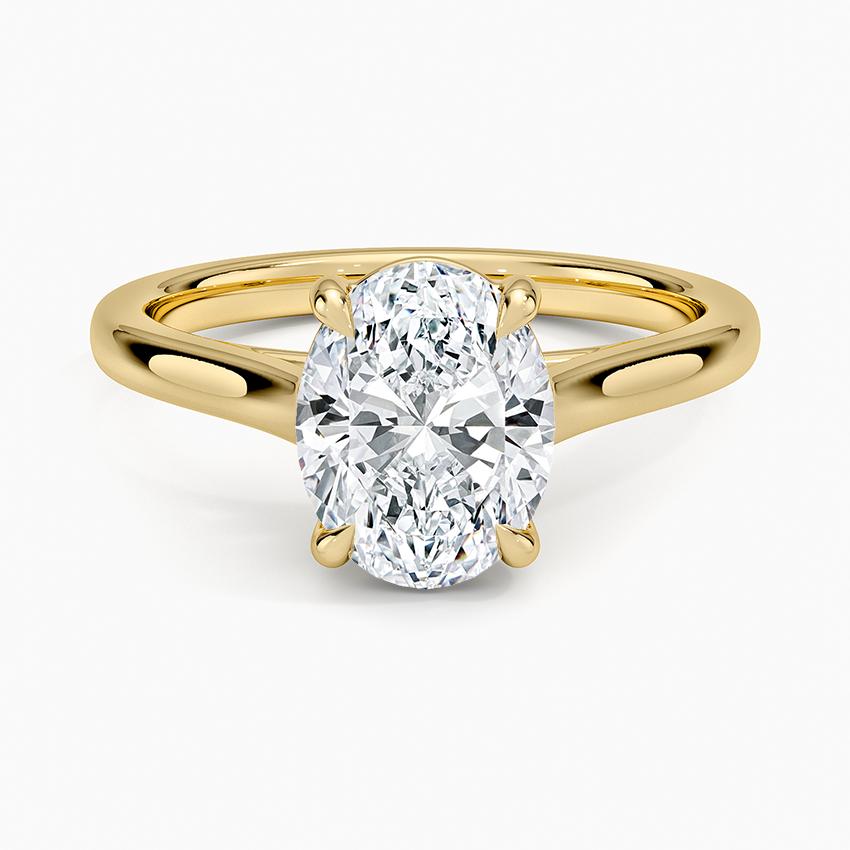 Oval moissanite solitaire on an open split shank in yellow gold, top view