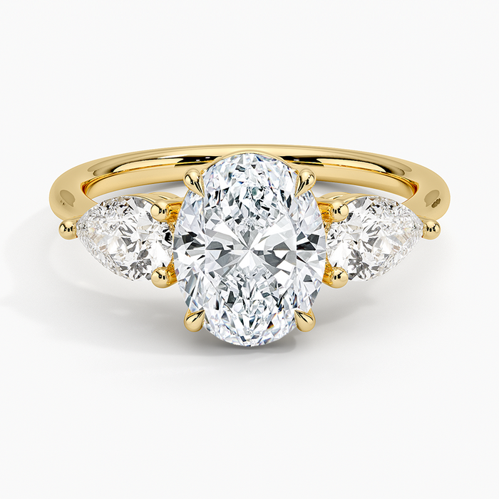 Oval moissanite open basket three stone pear ring in yellow gold, top view