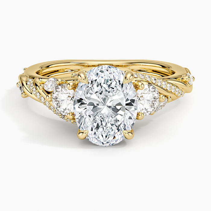 Oval moissanite three stone ring with marquise leaves and pave vine shoulders in yellow gold