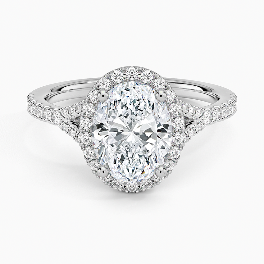 Oval moissanite with a pave halo and pave split shank in white gold, top view