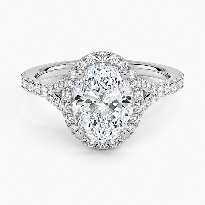 Oval moissanite with a pave halo and pave split shank in white gold, top view