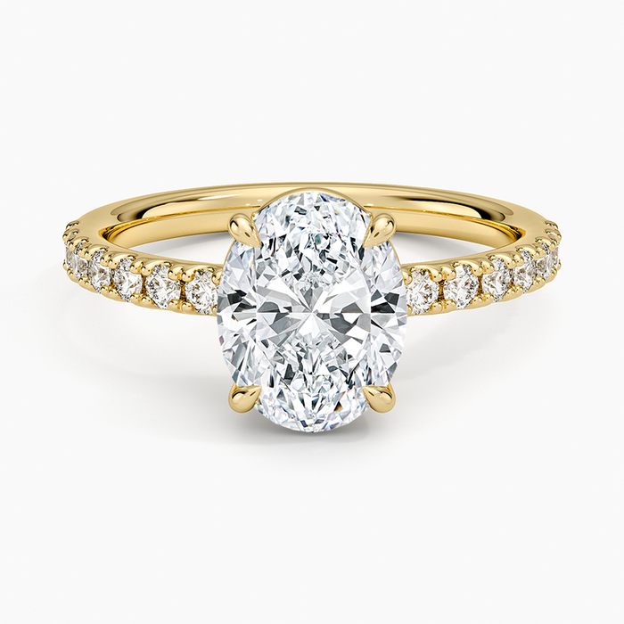 Oval moissanite solitaire with pave shoulders in yellow gold, top view
