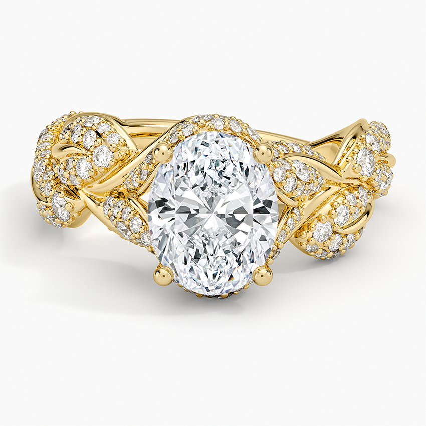 Oval moissanite halo ring with pave set vines and leaves in yellow gold, top view