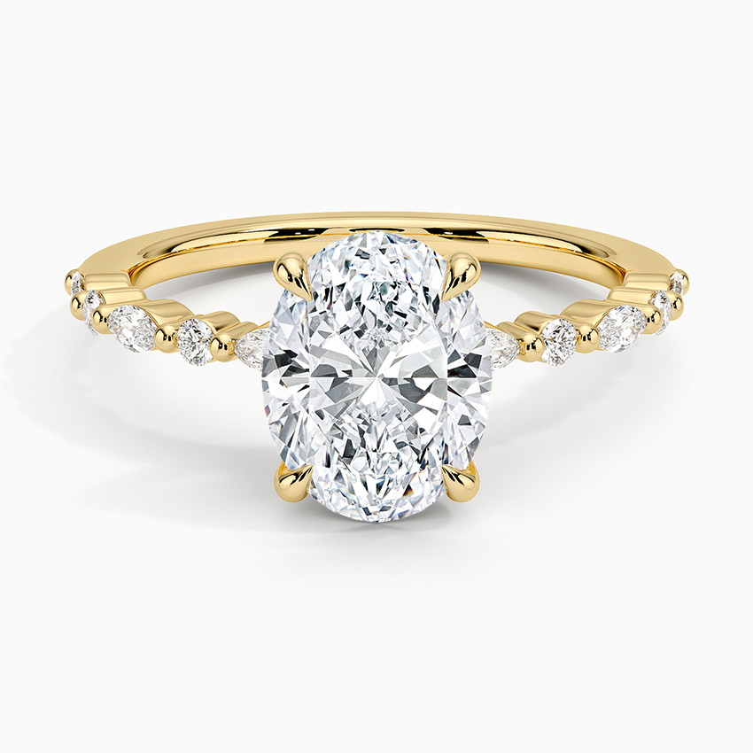 Oval moissanite ring with alternating marquise and round accents on a fine yellow gold band, top view