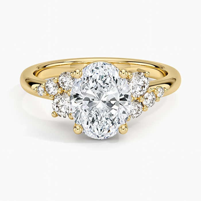Oval moissanite with graduated round clusters in yellow gold, top view