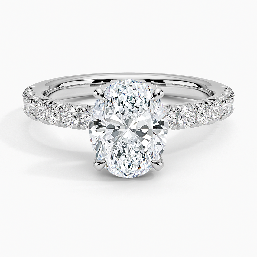 Oval moissanite with scalloped pave shoulders in white gold, top view