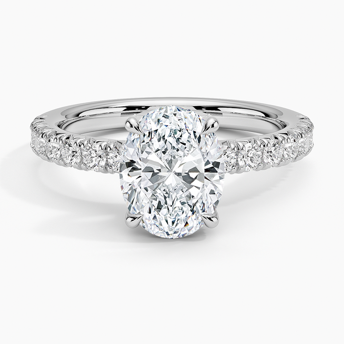 Oval moissanite with scalloped pave shoulders in white gold, top view