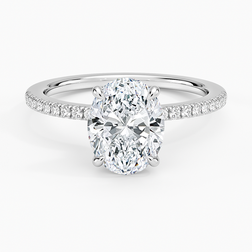 Oval moissanite on a scalloped pave white gold band, top view