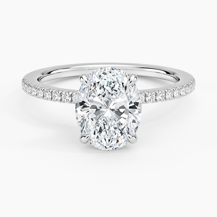 Oval moissanite on a scalloped pave white gold band, top view