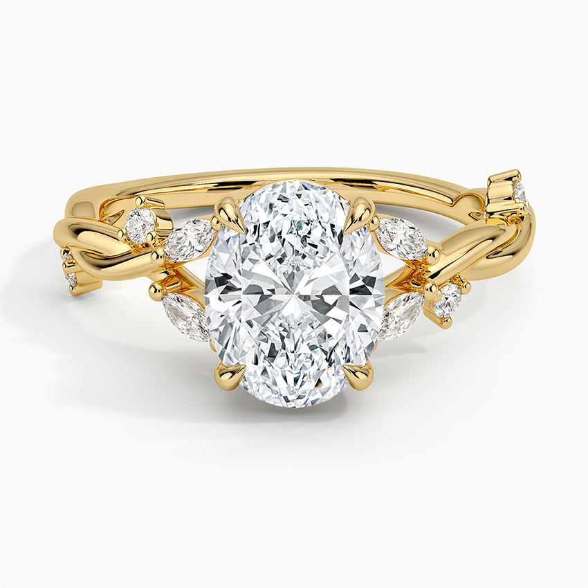 Oval moissanite on a scattered marquise branch band in yellow gold, top view