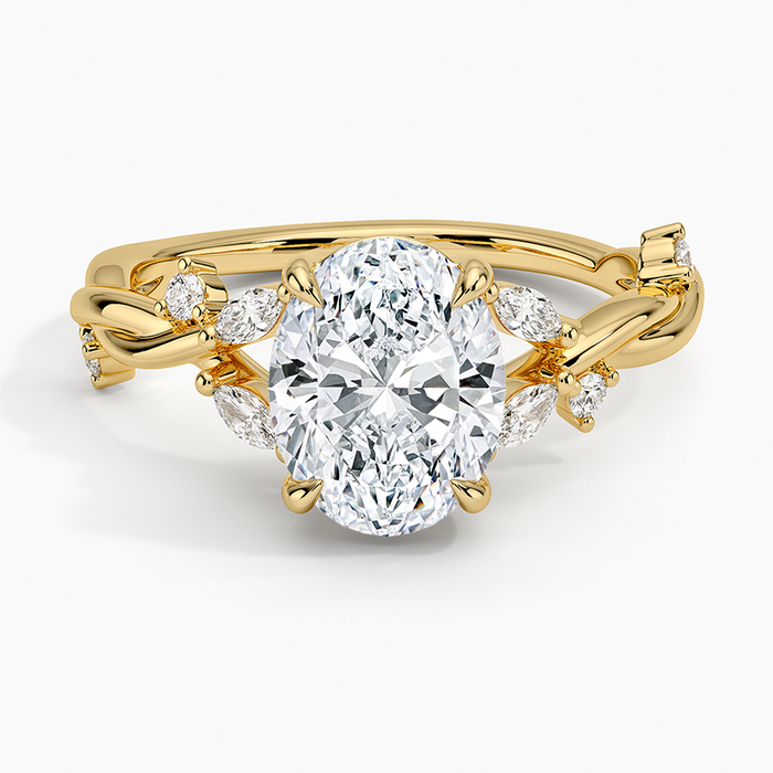Oval moissanite on a scattered marquise branch band in yellow gold, top view