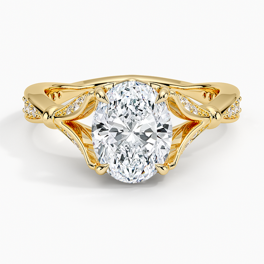 Oval moissanite framed by open pave scroll wings in yellow gold, top view