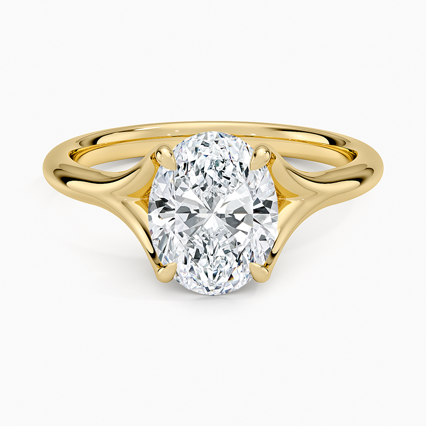 Oval moissanite solitaire on a sculpted chevron split shank in yellow gold, top view