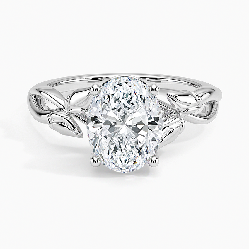 Oval moissanite solitaire on a sculpted metal leaf and vine band in white gold, top view